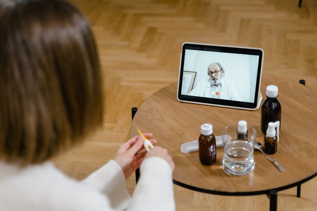 High-Angle Shot of Two Doctors Making a Zoom Call Using a Tablet Computer